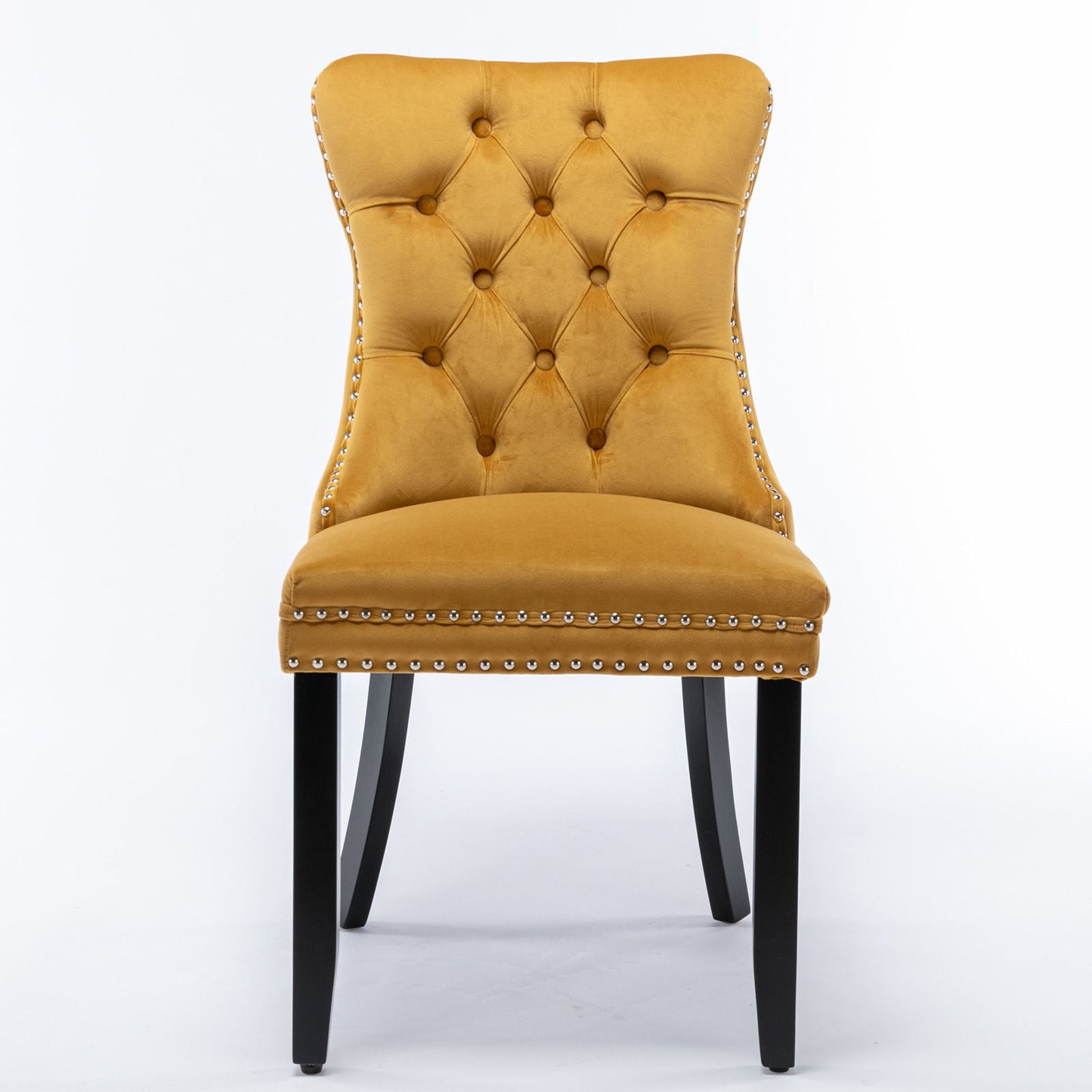 The Nikki set includes two modern, high-end mustard yellow velvet dining chairs with tufted backs, silver nailhead trim, and dark solid wood legs, shown against a white background.