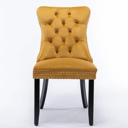 The Nikki set includes two modern, high-end mustard yellow velvet dining chairs with tufted backs, silver nailhead trim, and dark solid wood legs, shown against a white background.