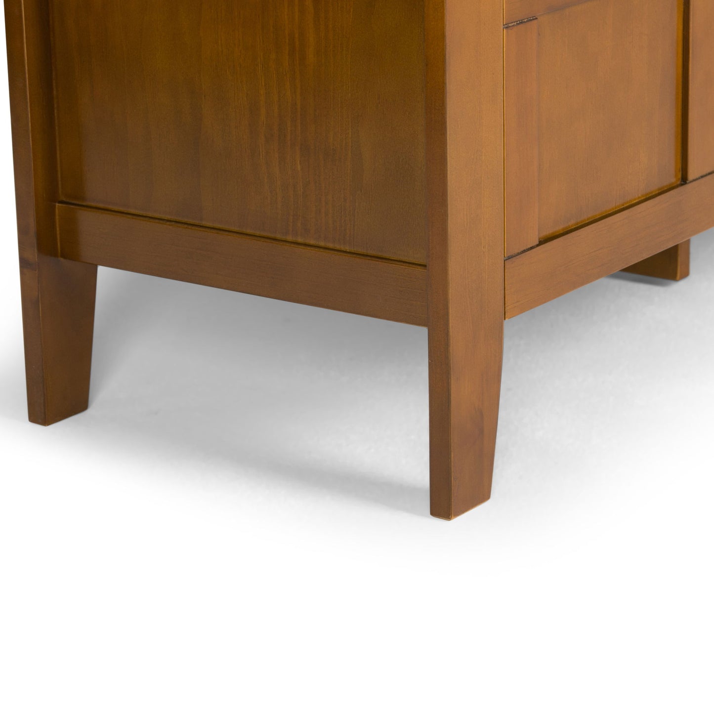 Close-up of the Adams - Entryway Storage Bench Handcrafted, highlighting its straight wooden legs and warm brown finish against a white background.