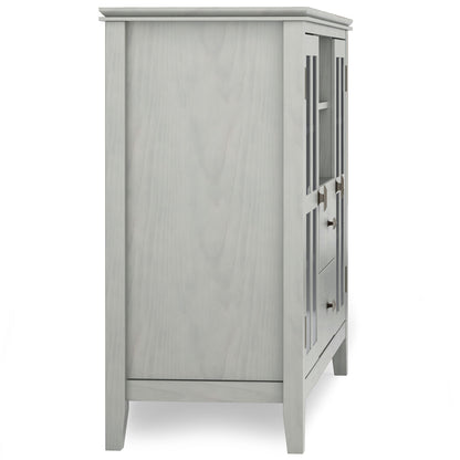 Side view of the Artisan Handcrafted Tall TV Media Stand in light gray, featuring paneled sides, straight legs, visible front door hinges and handles, and a smooth, minimalist design.