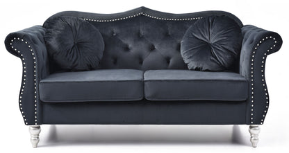 The Stylish Flared Arm Loveseat features a dark velvet finish, silver stud trim, tufted back, two round pillows, and silver legs, shown against a white background.