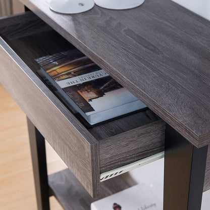 A close-up of the Modern Two Toned Console With Two Shelves, featuring an open drawer with magazines and papers inside. The console rests on a light-colored floor, with part of a white object visible on top.