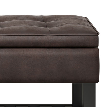 Close-up of the Cosmopolitan - Storage Ottoman Bench With Open Bottom, featuring dark brown tufted leather, a thick cushion, and black metal legs against a white background.