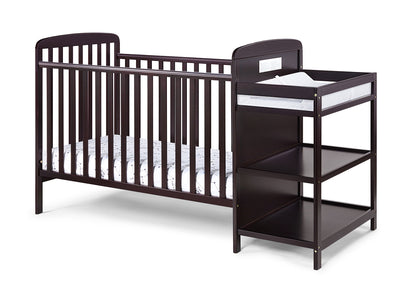The Ramsey 3-in-1 Convertible Crib / Changer Combo features a dark brown wooden crib with slatted sides, attached to a matching changing table with two open shelves and a cushioned changing pad on top.