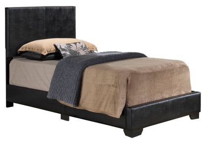The Elegant Platform Bed For Relaxed Spaces features a black upholstered headboard and frame, tan and beige bedding, a gray knitted blanket, and two pillows—one adorned with a floral pattern.