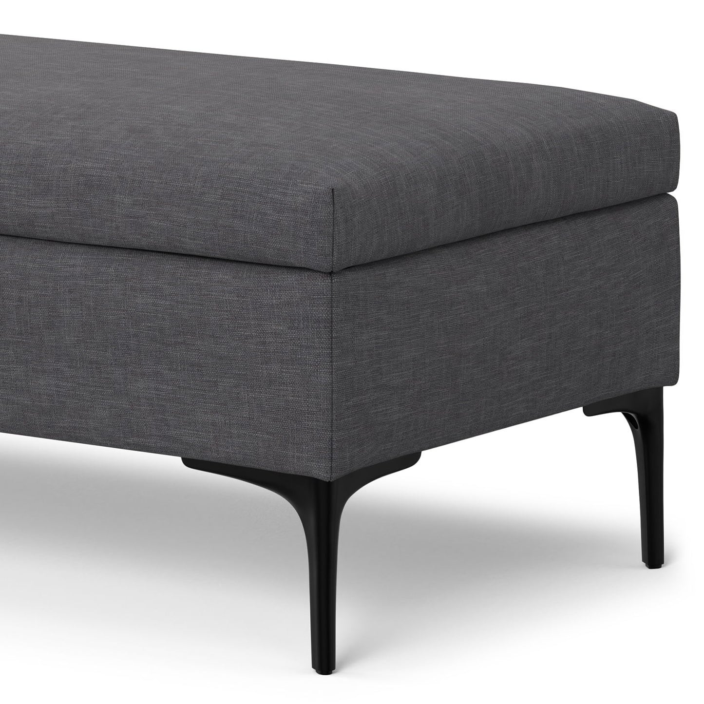 A close-up of the Rebecca Multifunctional Coffee Table Storage Ottoman with a rectangular dark gray upholstered design, slim black metal legs, and a lift-up lid, set against a white background.