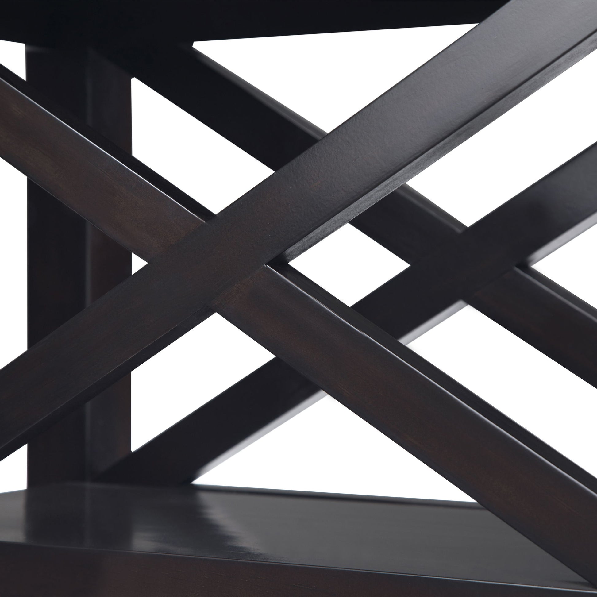 Close-up of the Kitchener - Handcrafted Table featuring dark wooden shelves with intersecting diagonal support beams in an X-shape. The white background highlights the table’s glossy finish and geometric design.