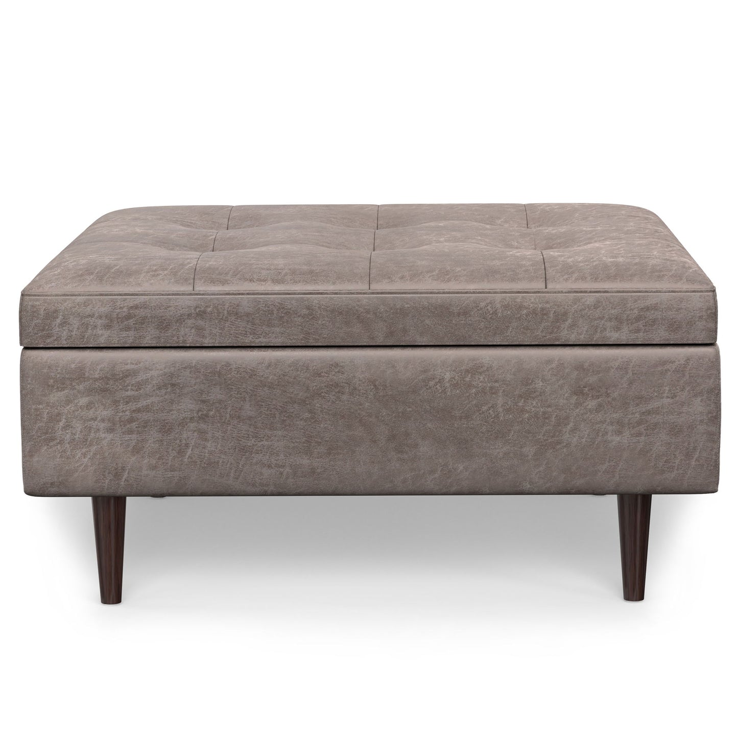 The Shay Large Square Coffee Table Storage Ottoman features light brown upholstery, subtle tufted top detailing, and four dark wooden legs in a mid-century style, displayed against a white background.