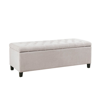 The Elegant Design Tufted Top, Soft Close Storage Bench features a rectangular, light beige upholstered build with a cushioned tufted top and short, dark wooden legs.