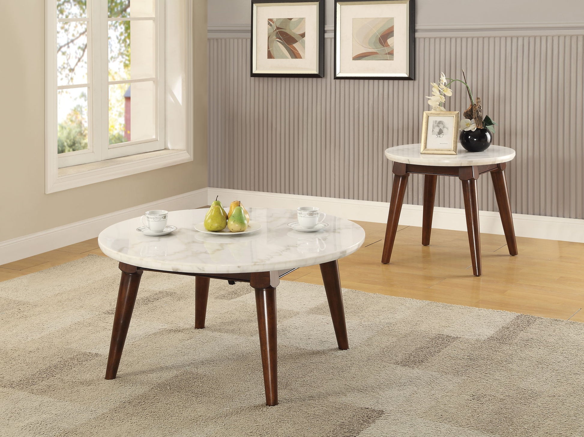 A living room features the Gasha Coffee Table in white marble and walnut, displaying fruit and cups; a matching side table holds vases. Framed wall art and a window can be seen in the background.