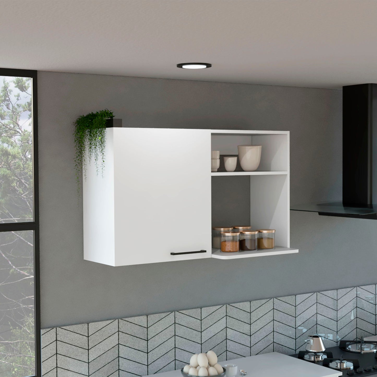 The Burwood Kitchen Wall Cabinet features two white doors with black handles, open shelving for jars and bowls, a small green plant on top, a gray chevron backsplash, and a window visible on the left.