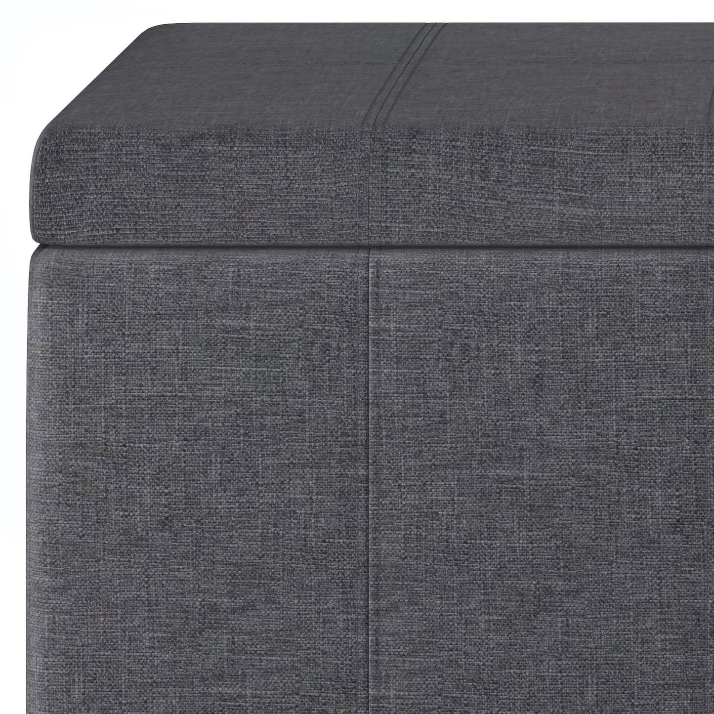 Close-up of the Dover Upholstered Storage Ottoman Bench in gray, featuring a rectangular shape, cushioned lid, subtle textured fabric, and stitched seam detailing.