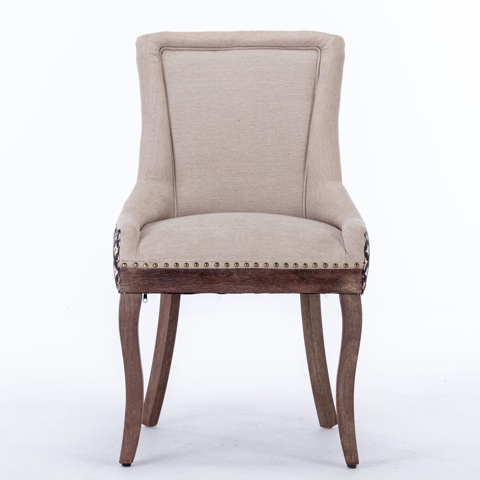 The Ultra Side Dining Chair set features thickened beige fabric, a tall curved backrest, bronze nailhead trim, and neutrally toned solid wood legs, shown here against a white background.
