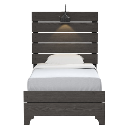 The Junipe - Bed With Lights is a dark wooden single bed with a tall slatted headboard, white bedding, and a pillow. A black pendant light hangs above, casting a warm glow on the headboard.