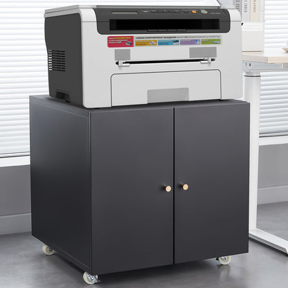 An Office Furniture Copier Cabinet 2 Door Steel Copier Stand Mobile Pedestal File Printer Stand holds a gray and black multifunction printer, standing on caster wheels in an office with light-colored blinds behind it.