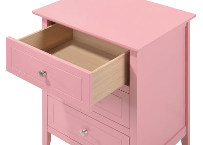 The Daniel 3 Drawer Nightstand is a pink wooden dresser featuring three drawers with silver round knobs; one drawer is open, revealing a light wood interior.