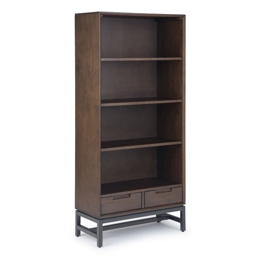 The Banting Mid Century Handcrafted Bookcase features a tall, dark wood design with three open shelves, two bottom drawers, and sturdy black metal legs.