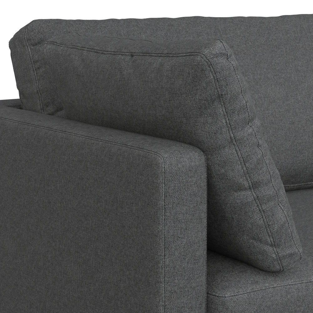 Close-up of the Ava Mid Century Upholstered Sofa in dark gray, featuring the armrest and a large cushion set against the backrest.