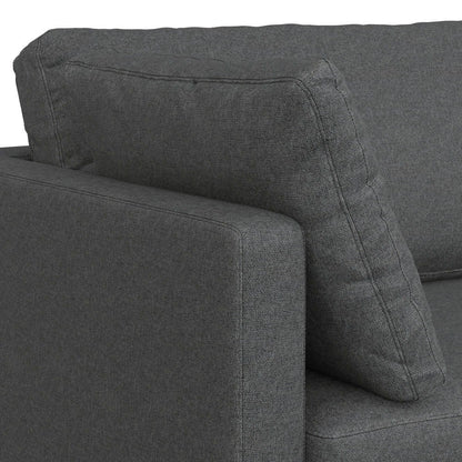 Close-up of the Ava Mid Century Upholstered Sofa in dark gray, featuring the armrest and a large cushion set against the backrest.