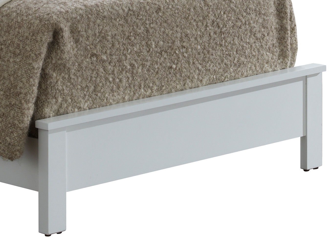 A close-up of the foot of the Bed With Transitional Design Stylish, featuring a white wooden frame and a thick beige textured blanket draped over it.