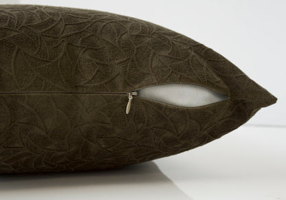 A close-up of a dark brown modern square decorative throw pillow with a subtle leaf pattern and a partially open zipper, revealing the white hypoallergenic insert included.