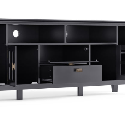 The Artisan TV Media Stand is a modern black unit featuring open shelves, a central pull-out drawer, two cabinets with doors, and circular cable management holes in the back panels.