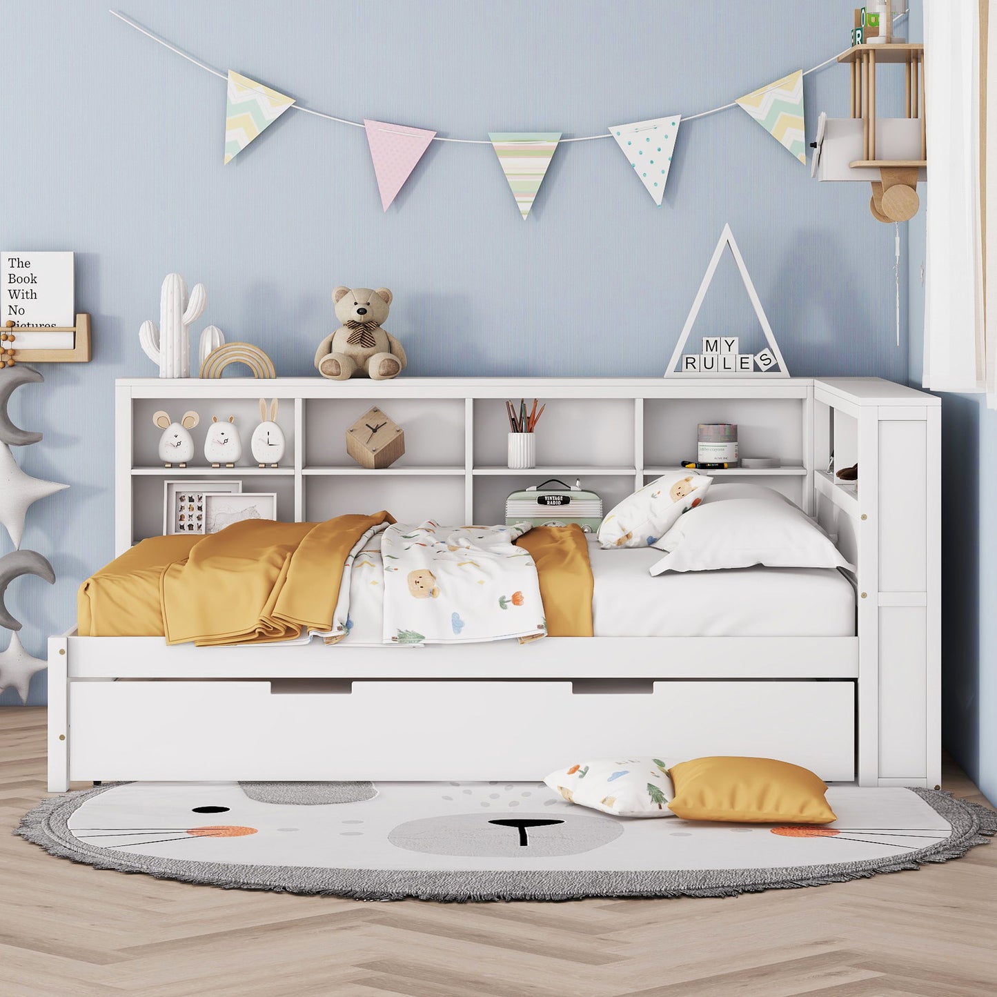 A cozy children's bedroom features the Wooden Full Size Daybed With Twin Size Trundle in white, with storage shelves and USB charging ports. Yellow and white bedding, colorful bunting on a blue wall, a round rug, and pillows complete the look.