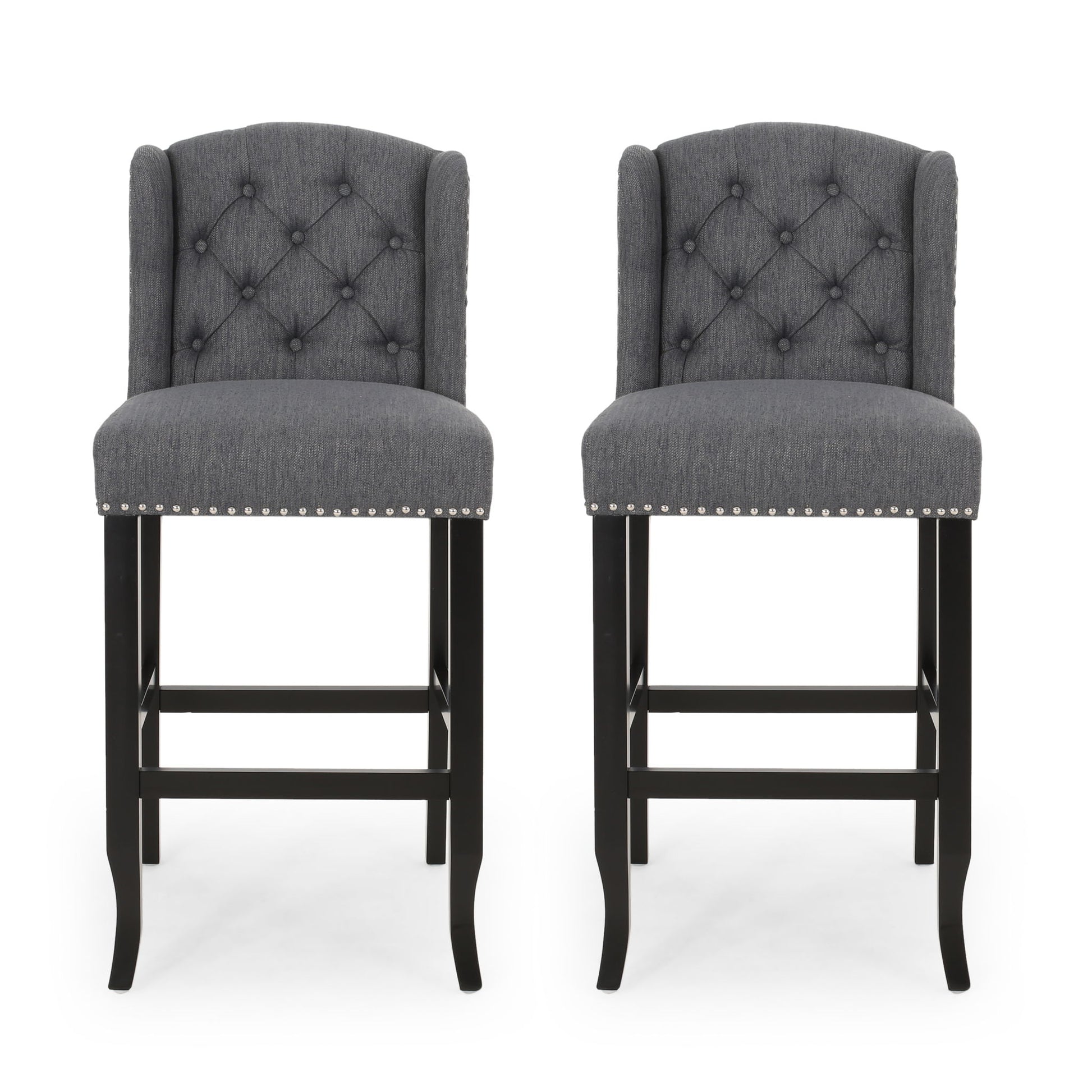 The Vienna - Contemporary Fabric Tufted Wingback Counter Stools (Set of 2) feature dark wooden legs, diamond-tufted gray fabric backs, and silver nailhead trim, shown side by side against a white background.