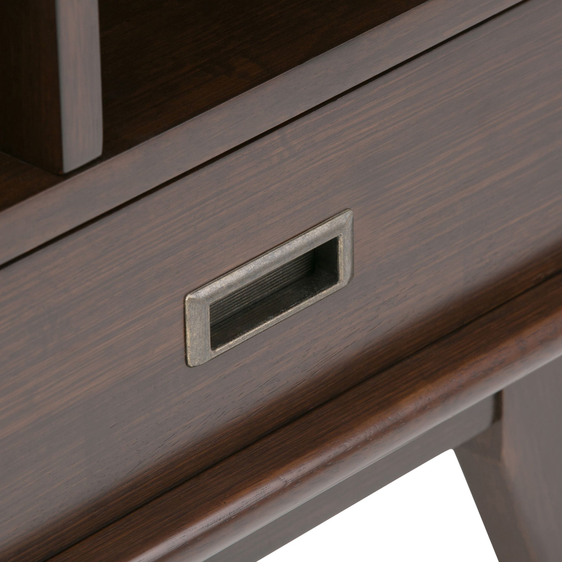 Close-up of the Draper - Mid Century Wide Bookcase And Storage Unit, featuring a dark wood drawer with a rectangular metal recessed handle and part of the drawer front and leg visible.