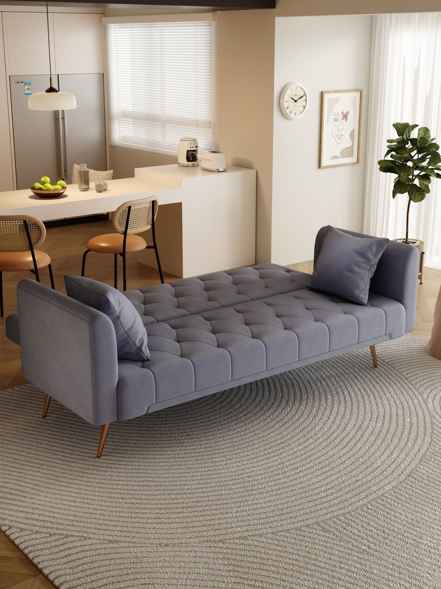 A modern living space featuring a gray Convertible Double Folding Living Room Sofa Bed with two matching pillows on a textured circular rug; kitchen stools, a plant, and wall art appear in the background.