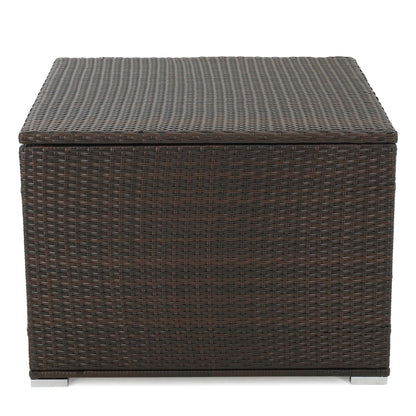 The Santa Rosa - Storage Table is a square, dark brown woven rattan outdoor storage box with a flat lid and short metal feet, pictured against a white background.
