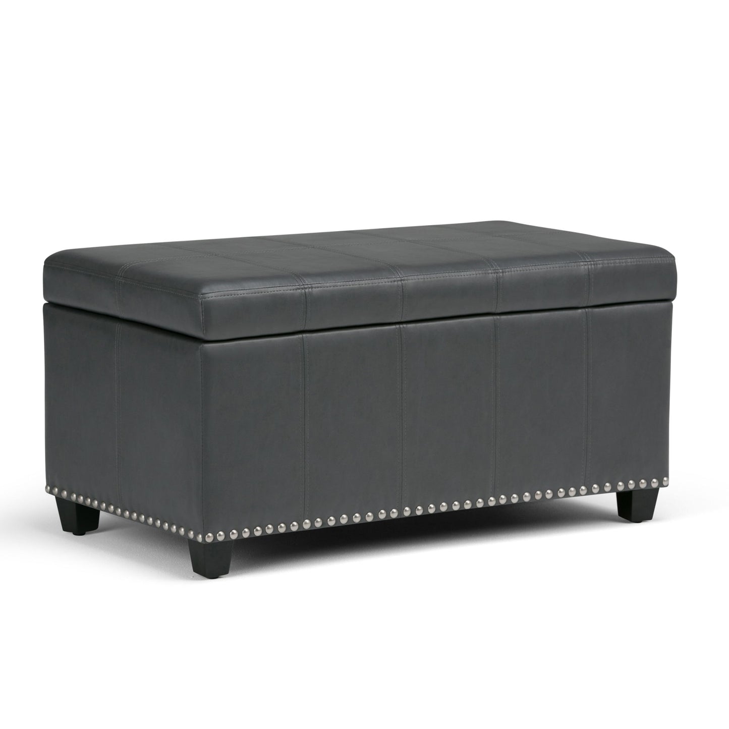 The Amelia Transitional Storage Ottoman Bench features a rectangular black leather design with a cushioned lid, decorative stitching, silver nailhead trim at the base, and short wooden legs.