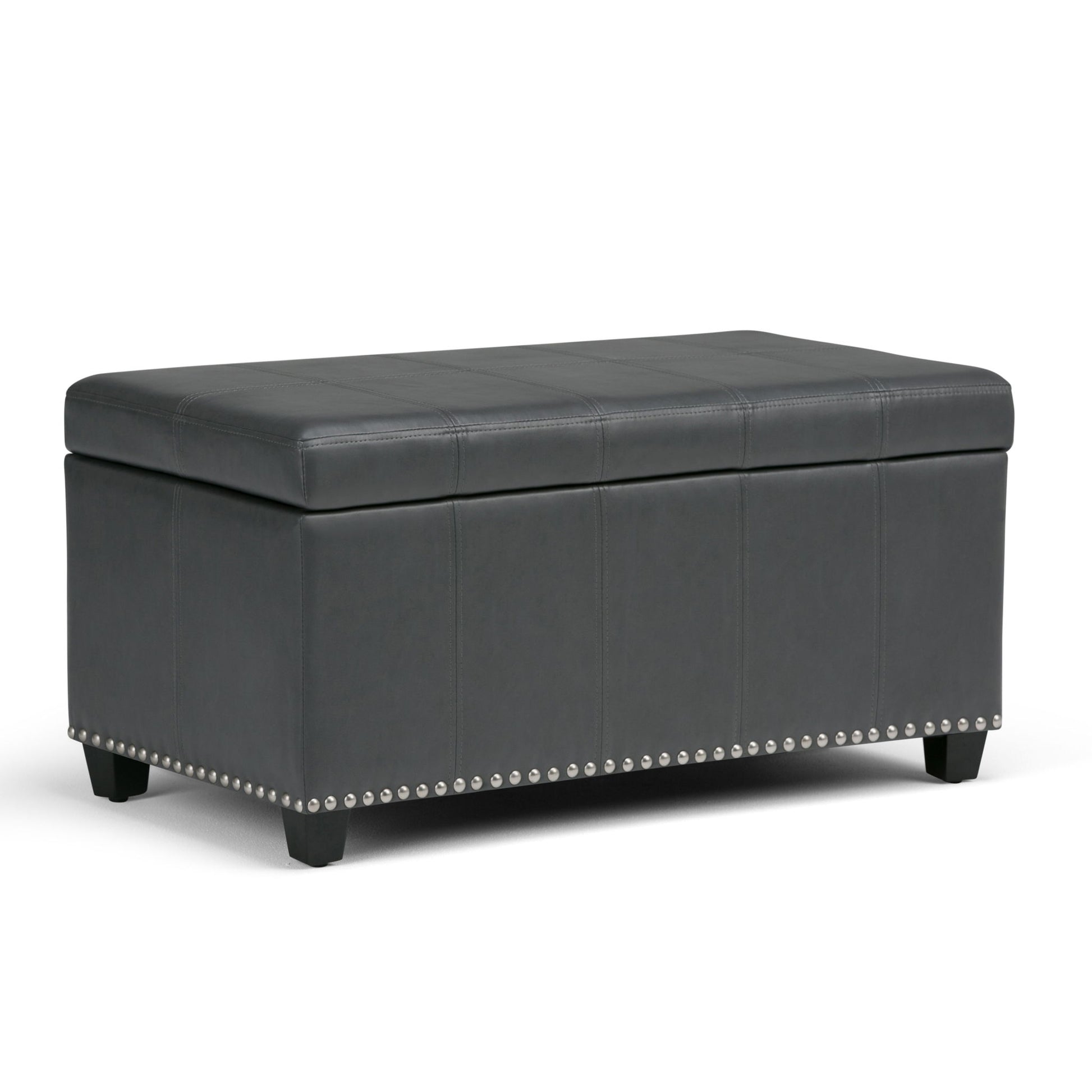 The Amelia Transitional Storage Ottoman Bench features a rectangular black leather design with a cushioned lid, decorative stitching, silver nailhead trim at the base, and short wooden legs.
