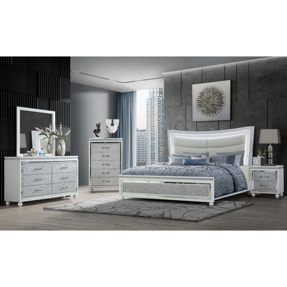 Modern bedroom featuring a large white bed, Couch.com Maloise Nightstand in gray finish, dressers, vanity, gray bedding, rug, decor accents, and a window showcasing a city skyline for a contemporary look.