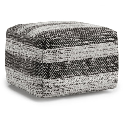 The Clay - Square Pouf, Upholstered features a woven textured fabric with horizontal black, white, and gray stripes, plus soft, rounded edges for a stylish accent.
