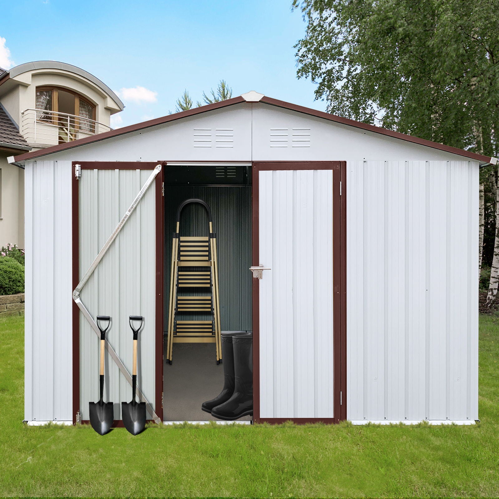 A 10' x 12' Garden Sheds Outdoor Storage Shed with white metal panels and brown trim sits on a green lawn. Its open doors reveal chairs, a ladder, and boots inside. Two shovels lean nearby, with a modern house and trees in the background.