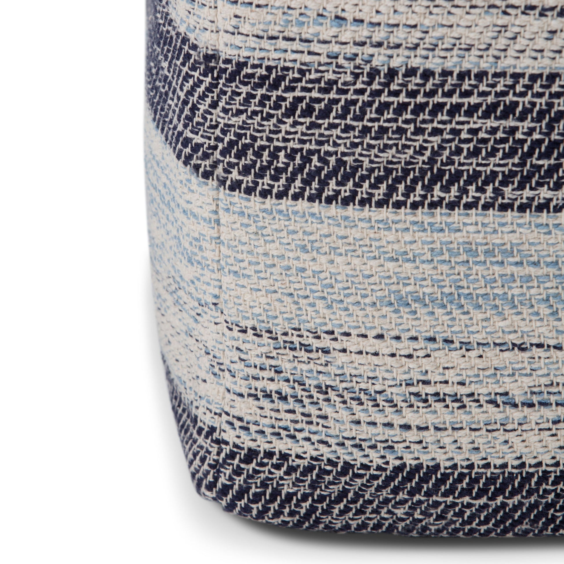 Close-up of the Clay - Square Pouf, Upholstered, showing woven fabric with horizontal stripes in navy blue, light blue, and cream. The texture of the threads and a visible corner seam add detail to the design.