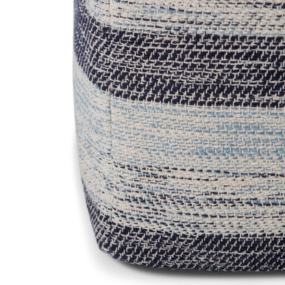 Close-up of the Clay - Square Pouf, Upholstered, showing woven fabric with horizontal stripes in navy blue, light blue, and cream. The texture of the threads and a visible corner seam add detail to the design.