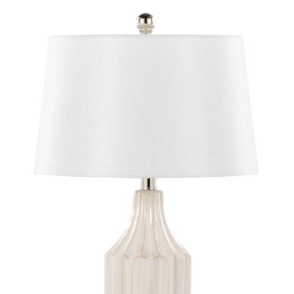 The Stella Contemporary Table Lamp features a beige ceramic base with vertical ridges, a white drum-shaped lampshade, and a silver finial for a stylish modern look.