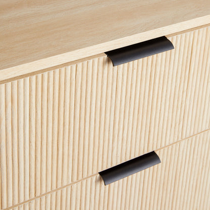 Close-up of the Mid-Century 3 Drawer Chest featuring reeded drawer fronts and modern black metal handles in light wood.