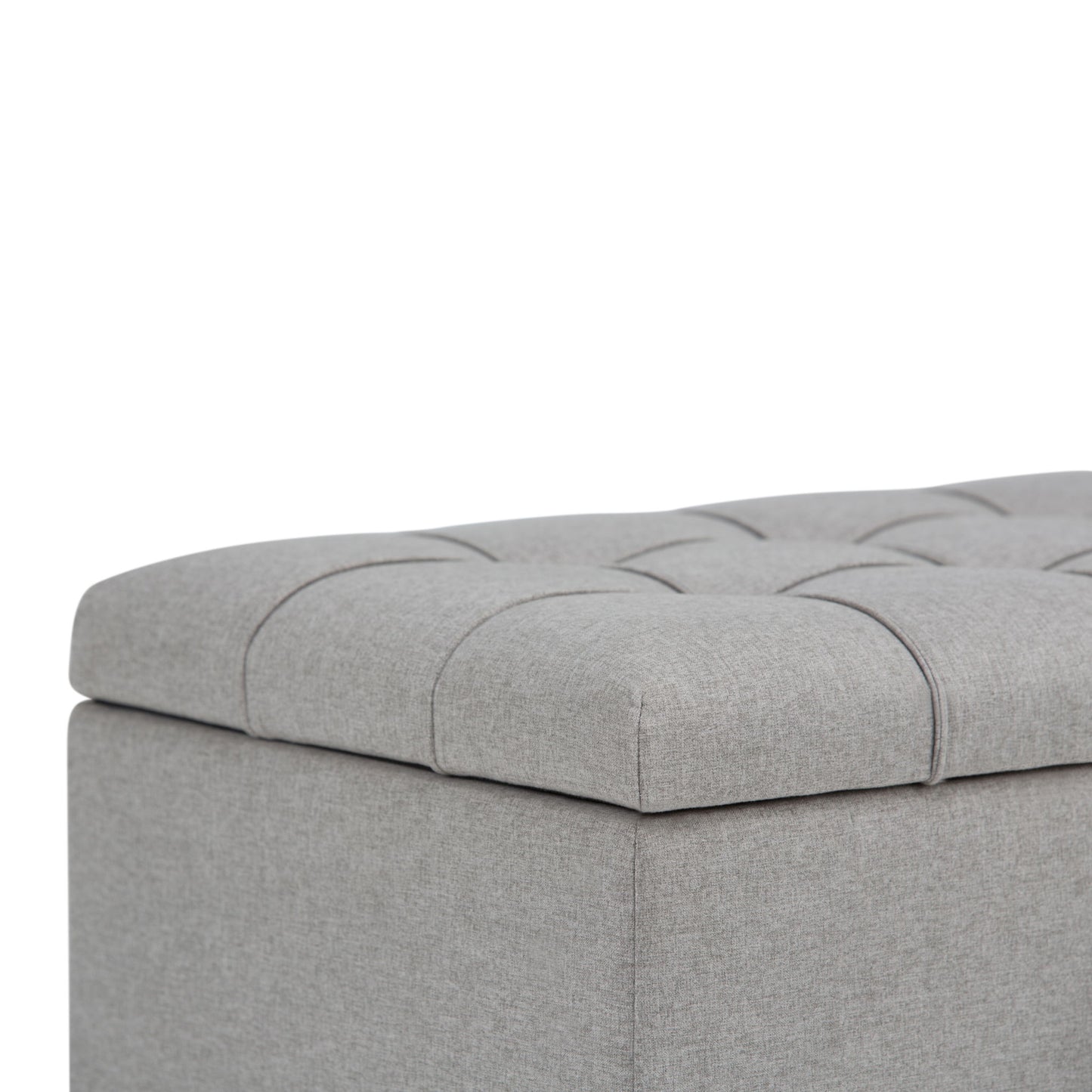 Close-up of the Sienna Upholstered Storage Ottoman Bench in light gray, featuring tufted fabric, visible stitching, and soft padding.