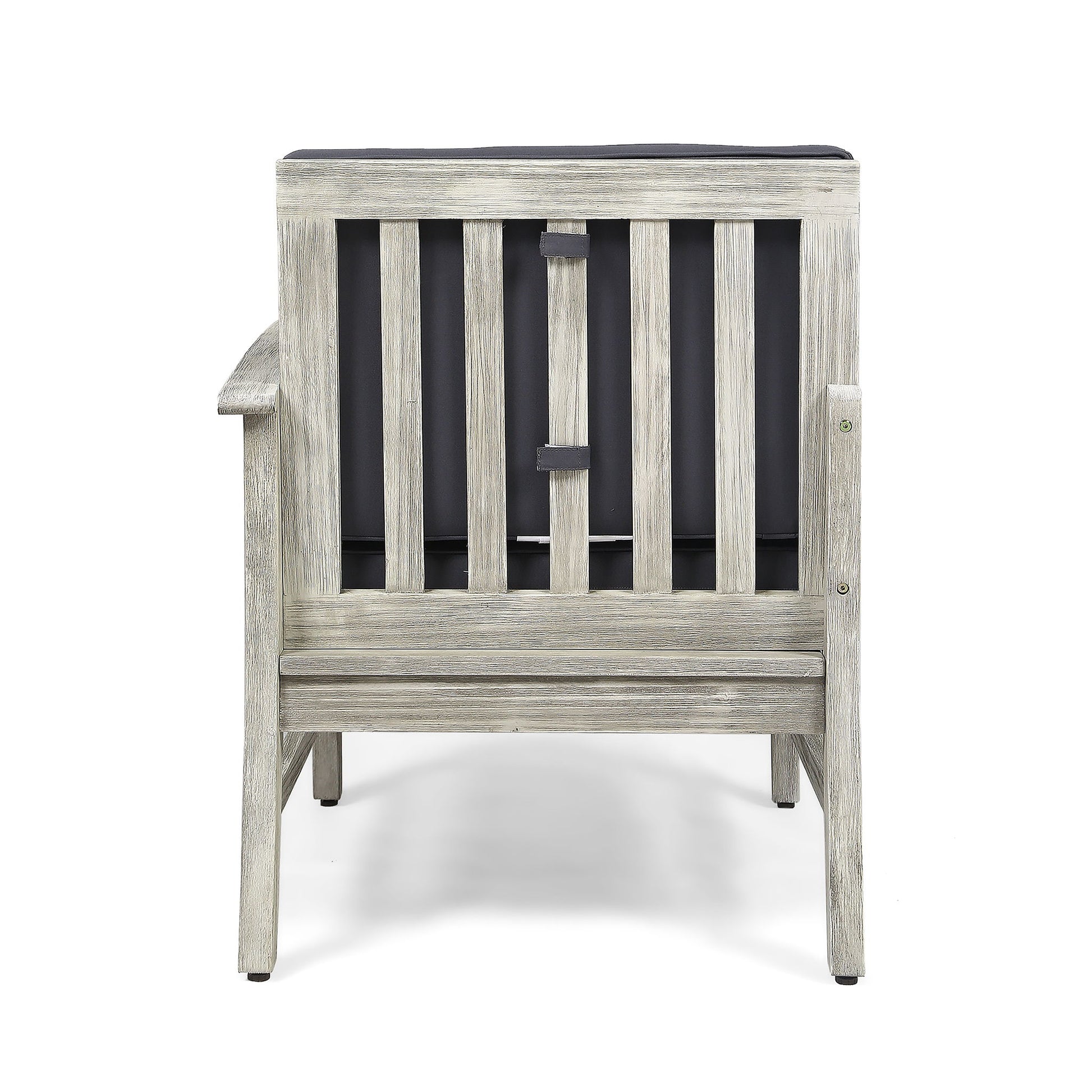 The Perla - Armchair is a wooden chair with a weathered gray finish, seen from the back, featuring vertical slats and a dark cushion attached to its backrest.