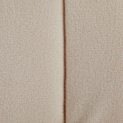 Close-up of the Braided - Versatile Round Ottoman in beige, showing its textured fabric and a vertical center seam. The material looks soft and inviting, adding warmth and style to any space.