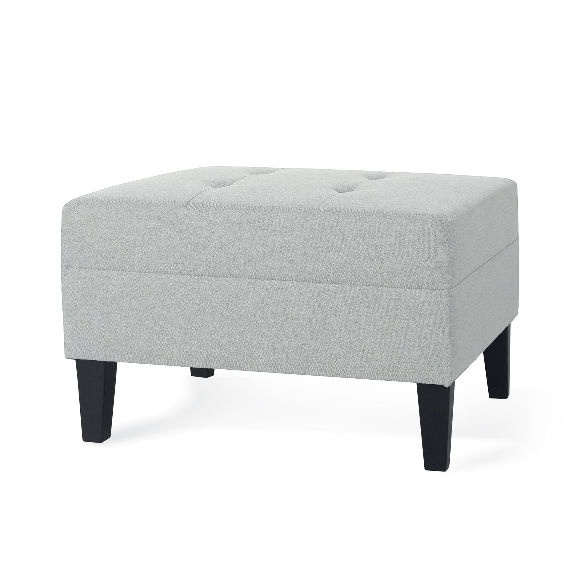 The Classic Ottoman features light gray fabric upholstery, a rectangular tufted top, and four black birch wood legs.