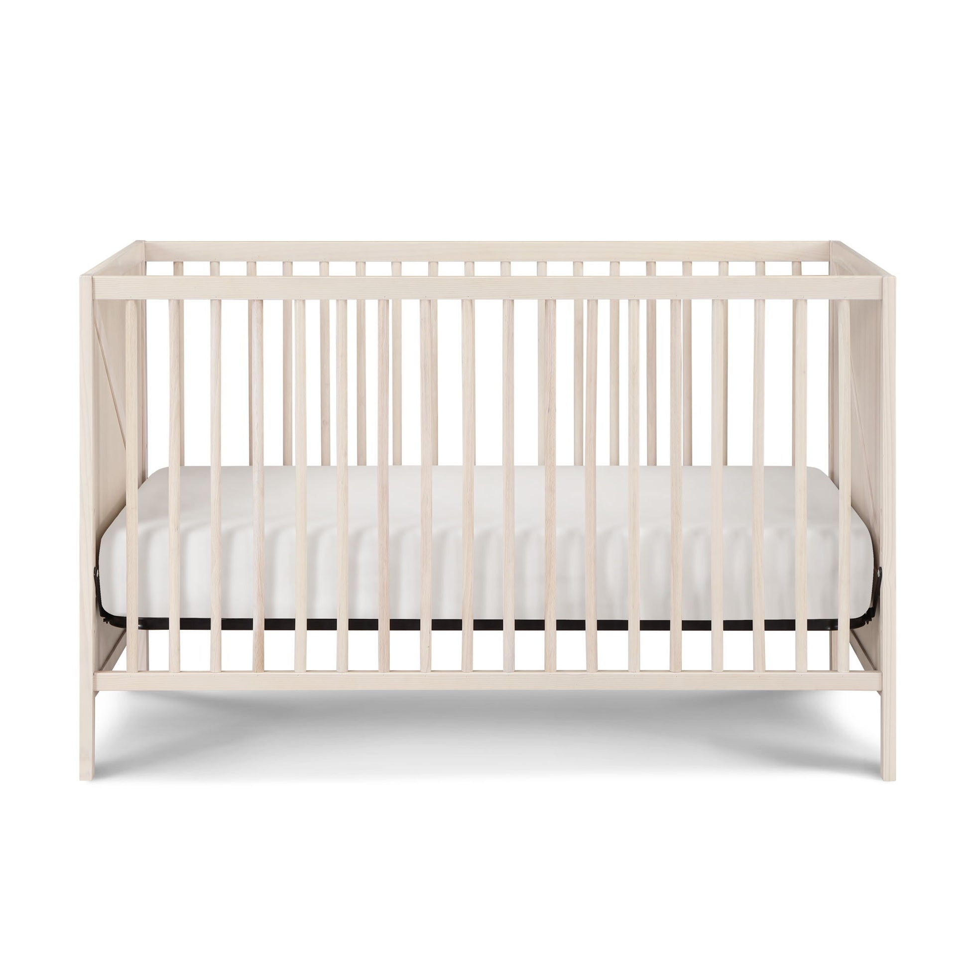 The Pixie Zen 3-in-1 Crib in walnut features vertical slats on all sides and includes a white mattress, displayed against a plain white background.