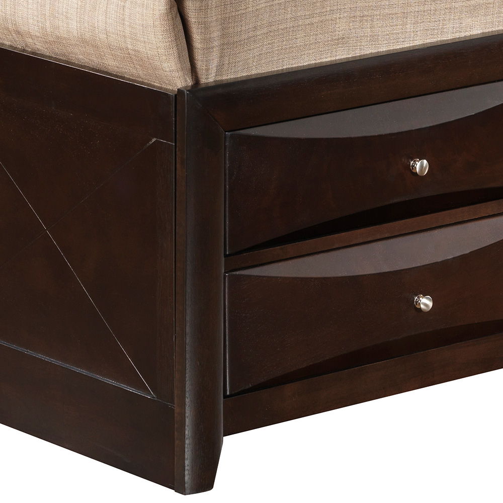 Close-up of the Marilla Storage Bed With Bookcase Headboard showing its dark wood corner, two built-in drawers with silver knobs, and a beige upholstered cushion on top.