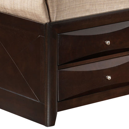 Close-up of the Marilla Storage Bed With Bookcase Headboard showing its dark wood corner, two built-in drawers with silver knobs, and a beige upholstered cushion on top.