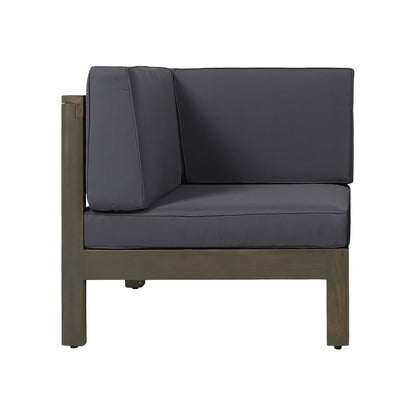 The Oana 3 Piece Sofa Set features a modern outdoor corner chair with water resistant dark gray cushions and a wooden frame, shown from the side against a white background.