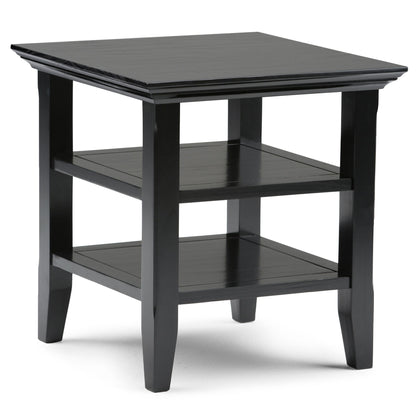 The Acadian - Handcrafted End Table is a black wooden piece with a square top, two lower shelves, and four straight legs, featuring a simple modern design.