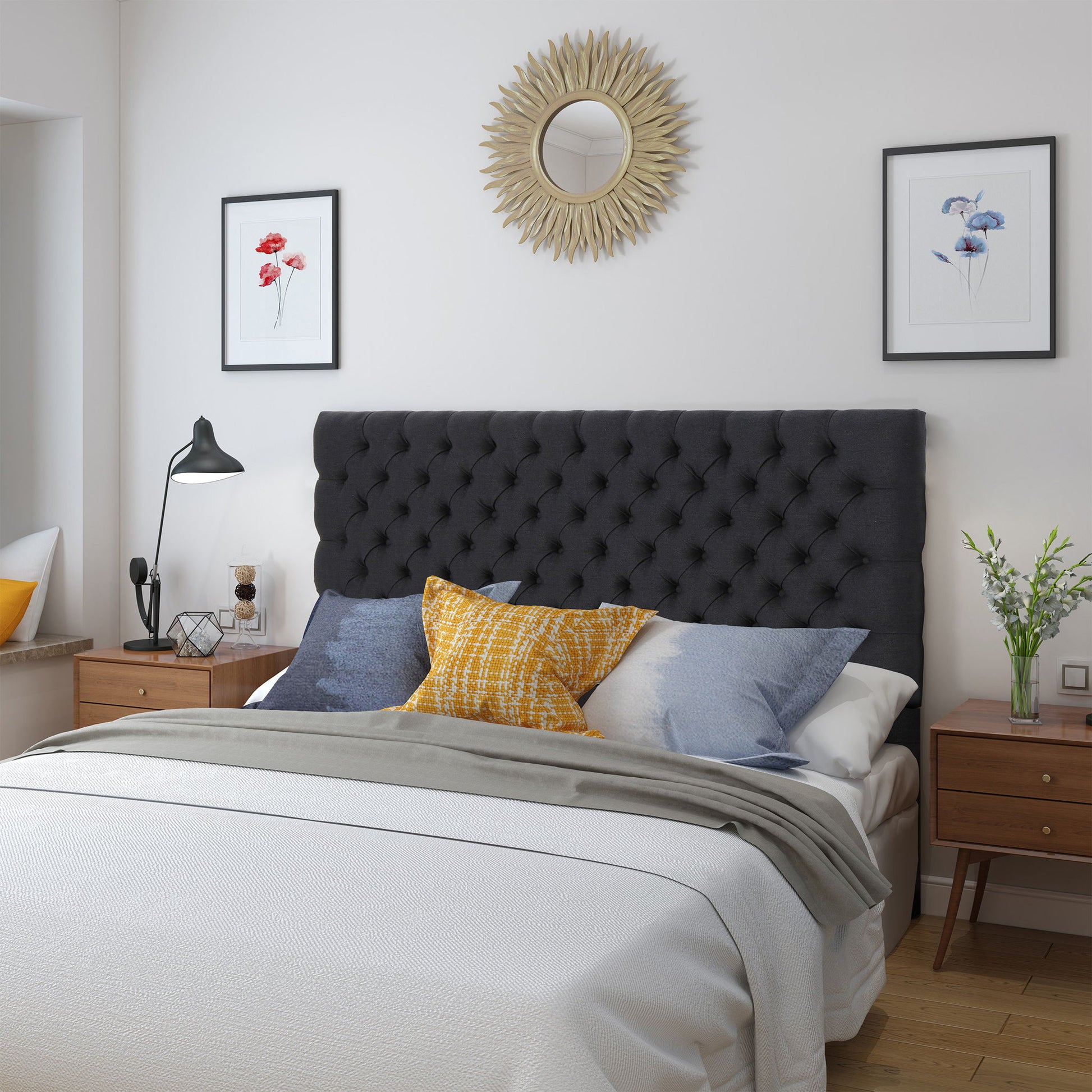 A neatly made bed with the Annecy - Contemporary Upholstered Headboard, yellow and blue accent pillows, wooden nightstands, a modern lamp, wall art, and a sunburst mirror above. The cozy room exudes a modern vibe.